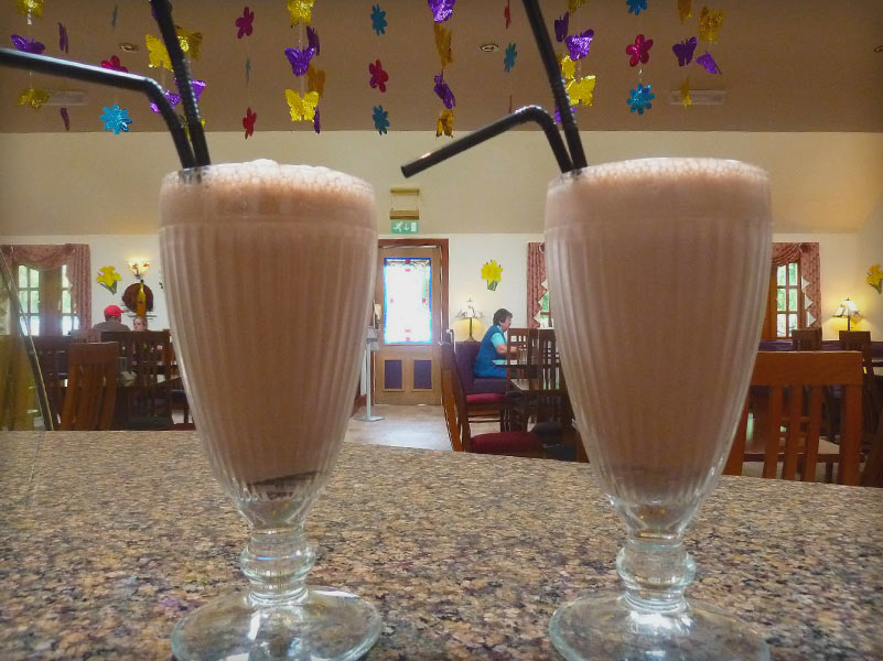 2 Chocolate milkshakes with black straws