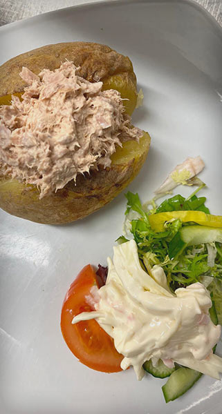 Baked potato with tuna mayo and a salad garnish
